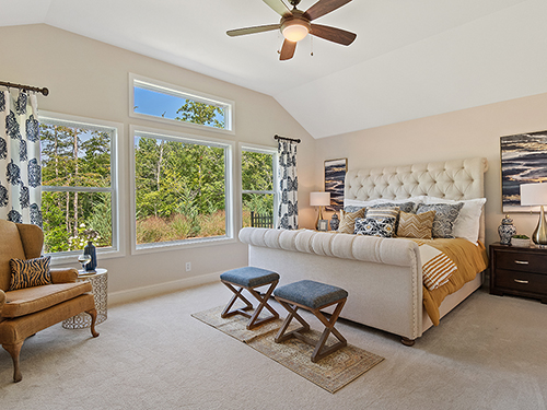 Gracious owners bedroom with large windows bringing plenty of natural light in.>